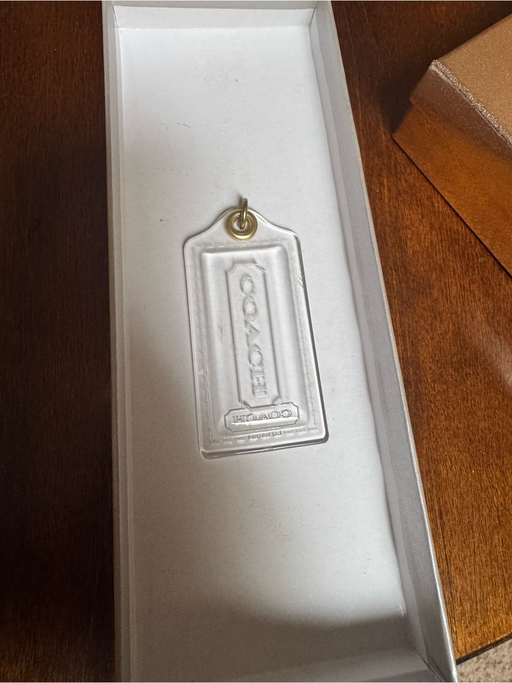 authentic Coach Poppy XL 3.5-inch clear acrylic plastic fob hang tag